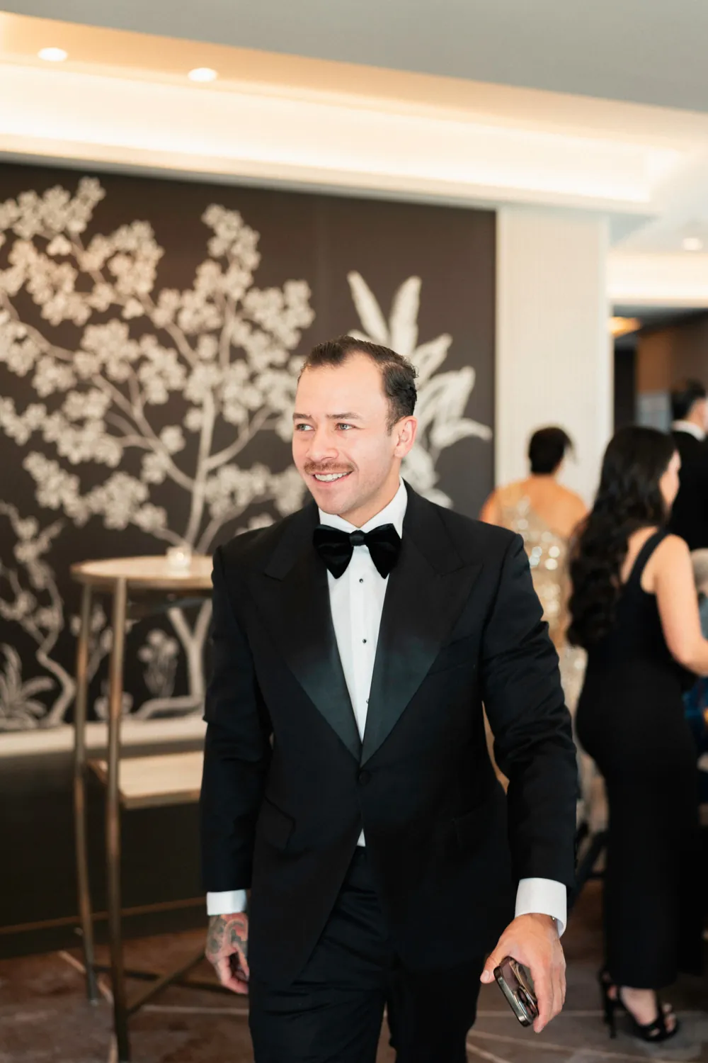 A client in a made to measure black tuxedo at a formal event.