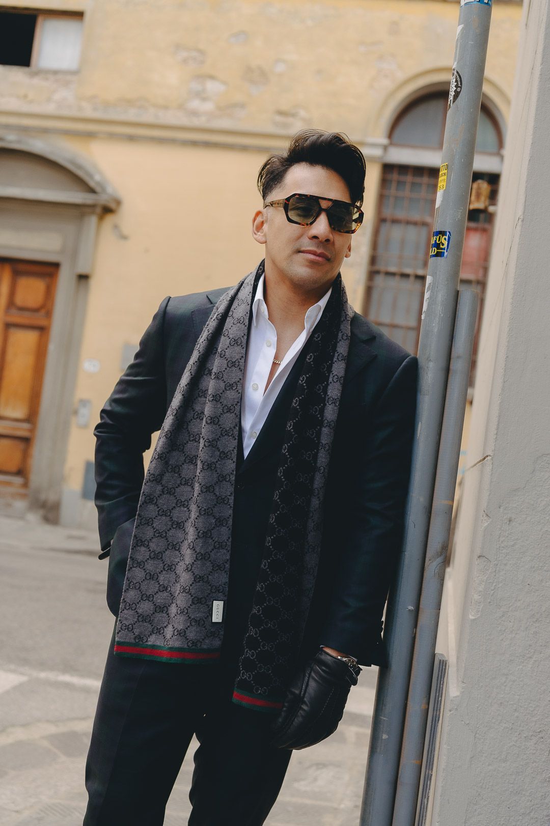 Doug in a dark navy suit and white shirt on a Florence street.